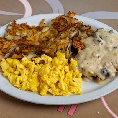 Chicken Fried Chicken served with scrambled eggs and hash browns.
