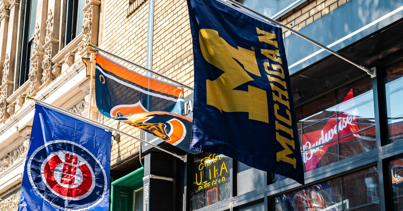 Our flags ourside - Chicago cubs, Chicago Bears and Michigan Wolverines