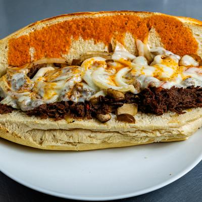 Steakout Hoagie, with mushrooms, peppers, onions, Buffalo sauce, and cheese.