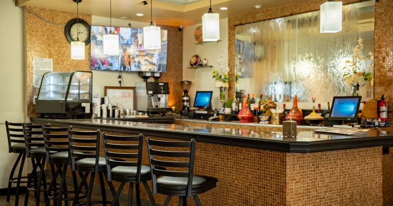 Bar, chairs, tv screen above