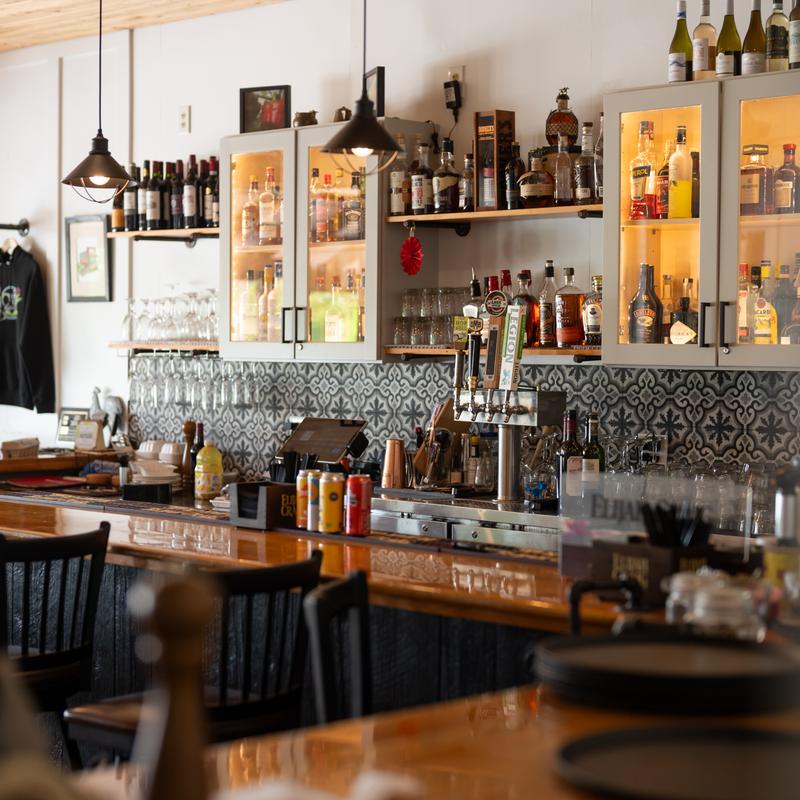 full bar set up with bottles and taps along the wall