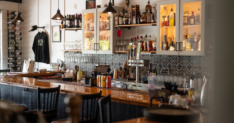 full bar set up with bottles and taps along the wall