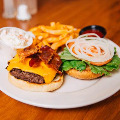 Bacon Cheeseburger served with french fries, ketchup, and coleslaw.
