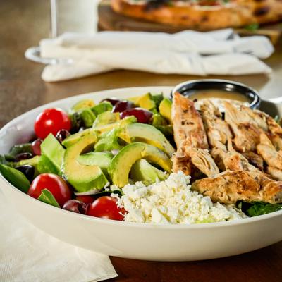 Mediterranean chicken salad with avocado and tomatoes.