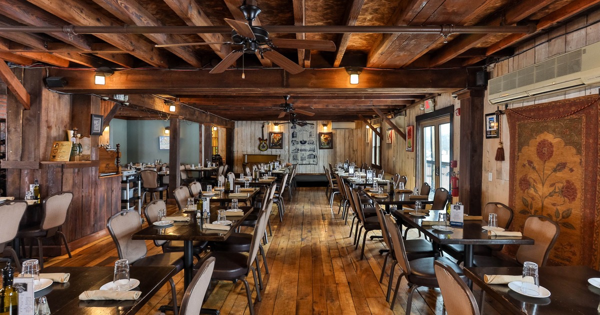 Inside, wooden beams, tables, and set dining areas