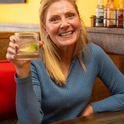 A cheerful customer holding a drink.