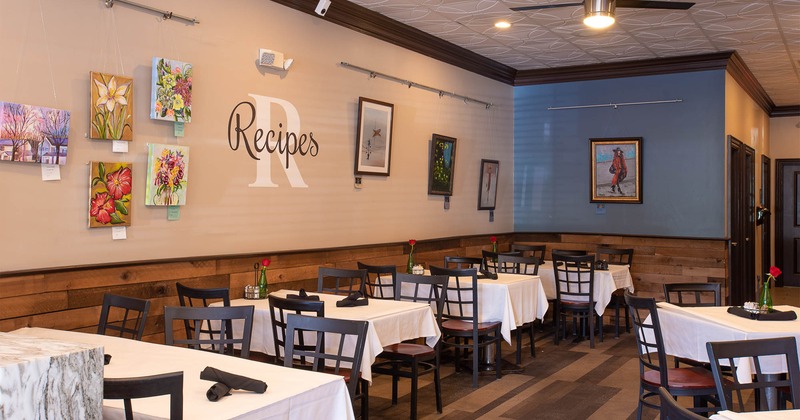 Interior, tables by the wall with pictures