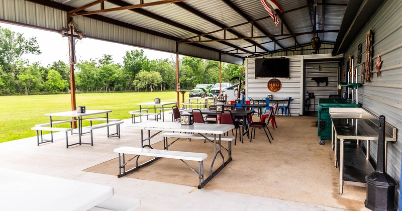 Interior, covered seating area with tables and chairs