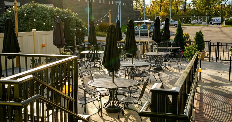 Outdoor patio seating area, tables and chairs with parasols