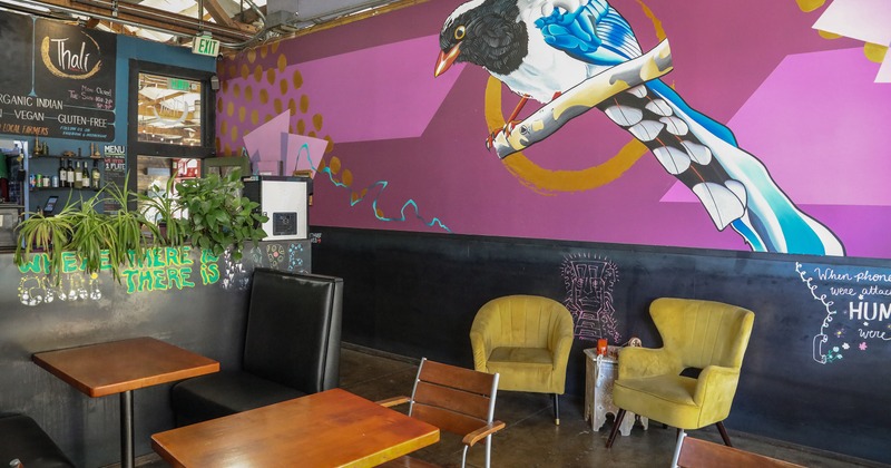 Interior space, seating area, a large mural on the wall showing a stylized bird