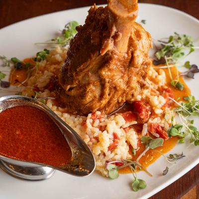 Pork shank osso buco with saffron vegetable risotto.