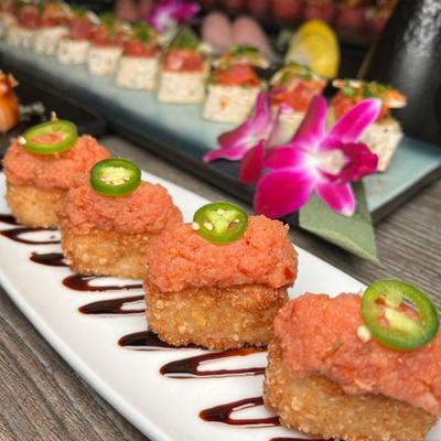 Crispy sushi rice topped with spicy tuna, Serrano peppers, and eel sauce.