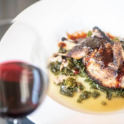 Red wine in a glass and the Texas Quail meal.