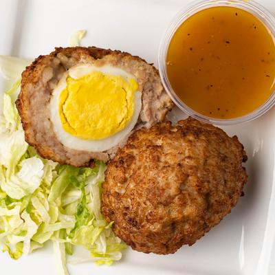 Hard-boiled egg wrapped with breakfast sausage with honey mustard sauce