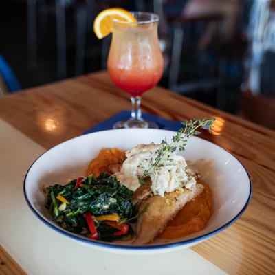 Fresh Catch dish plate and a glass of Tropical Martini.