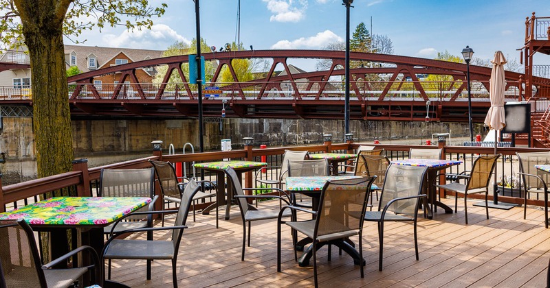 Exterior, uncovered seating area, tables for three and four people, river view