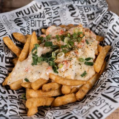 Loaded Cajun fries with melted cheese and diced green onions.