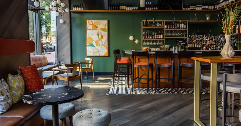 Interior with a bar, tables, and modern decor