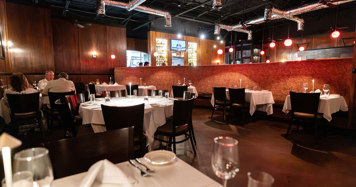 Interior of an elegant restaurant dining room with set dining tables