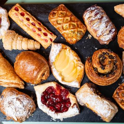 Assortment of artisanal pastries including croissants, danishes, and turnovers.