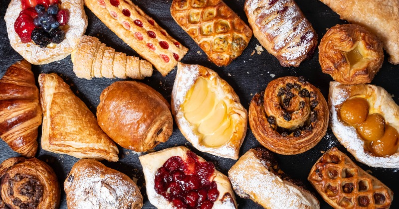 Diverse assortment of pastries including croissants, danishes, and strudels