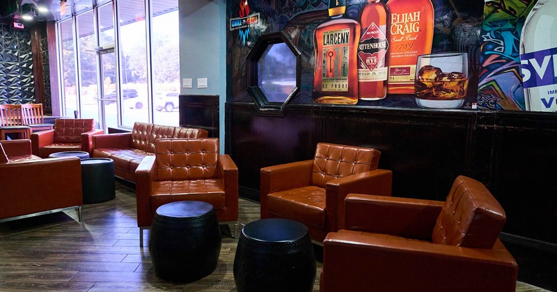 Lounging area, leather armchairs, sofas, and ottomans