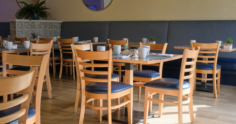 Interior, hip level shot, tables and chairs ready for guests