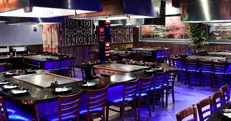 A table for the preparation of a sushi bar, there are chairs around