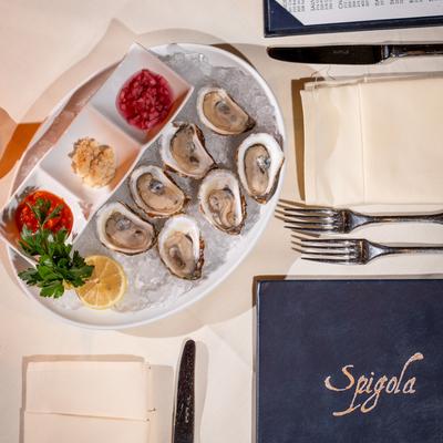 Fresh oysters on ice served with mignonette sauce and cocktail sauce.