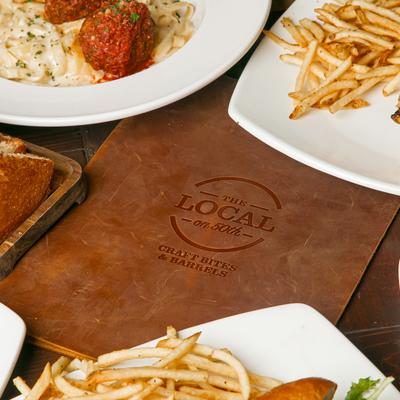 Restaurant's menu surrounded by food plates.