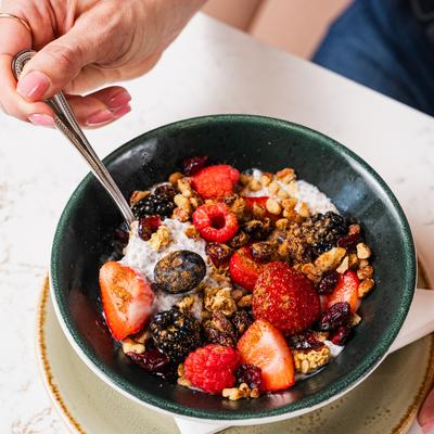 A bowl of granola with berries and yogurt.