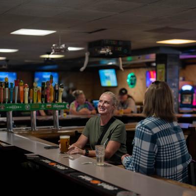 Interior, guests at a bar counter.