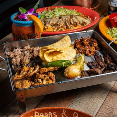 Mexican griddle filled with grilled meats, tortillas, grilled jalapeno and onion.