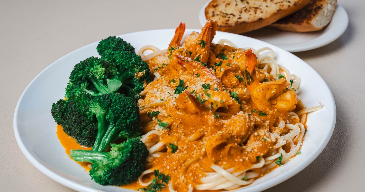Shrimp Fra Diavolo served over spaghetti with a side of broccoli
