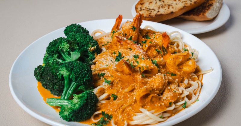 Shrimp Fra Diavolo served over spaghetti with a side of broccoli