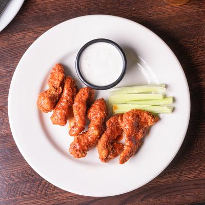 Boneless Buffalo Wings, with celery, and blue cheese dip.