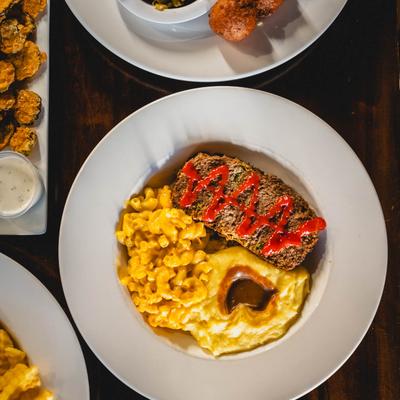 Meatloaf, with mashed potatoes, gravy, and mac and cheese.