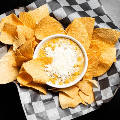Tortilla chips served with a cheese dip.