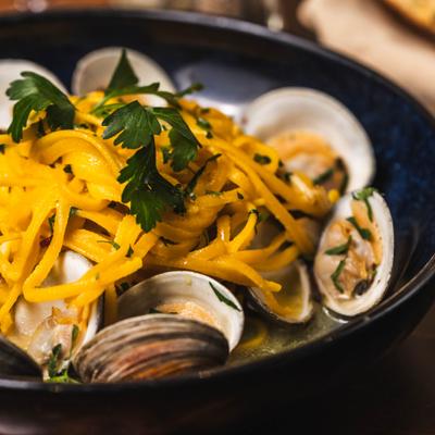 Seafood pasta with clams garnished with parsley.