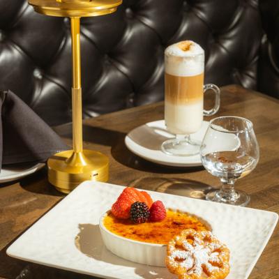 Creme brulee accompanied with a latte macchiato.