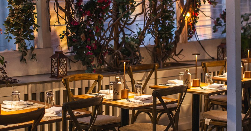 Interior, dining area with tables fully set for guest