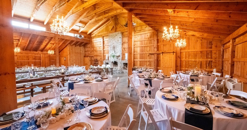 Interior, barn event space, lavish table arrangements, weeding setup, wooden walls