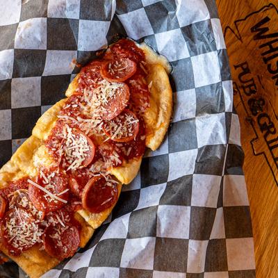 Pierogis topped with pepperoni.