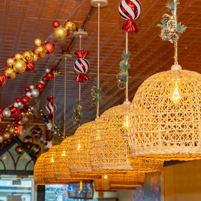 Several woven, bell-shaped pendant lights hanging from the ceiling.