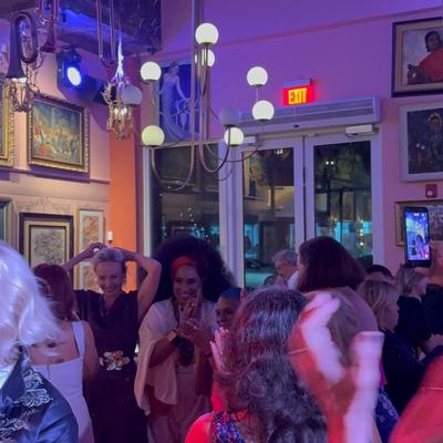 People dancing on the dance floor while the band is playing.