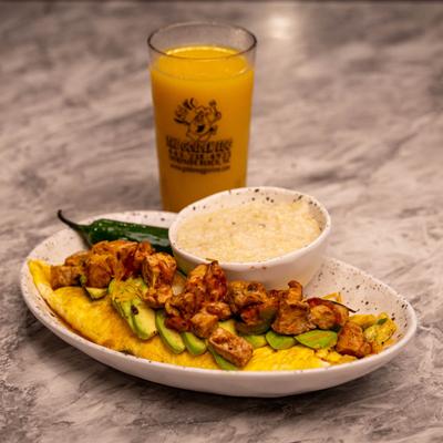 Omelet with avocado and diced meat.