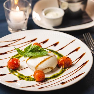 Burrata cheese, with cherry tomatoes, basil pesto and balsamic vinaigrette