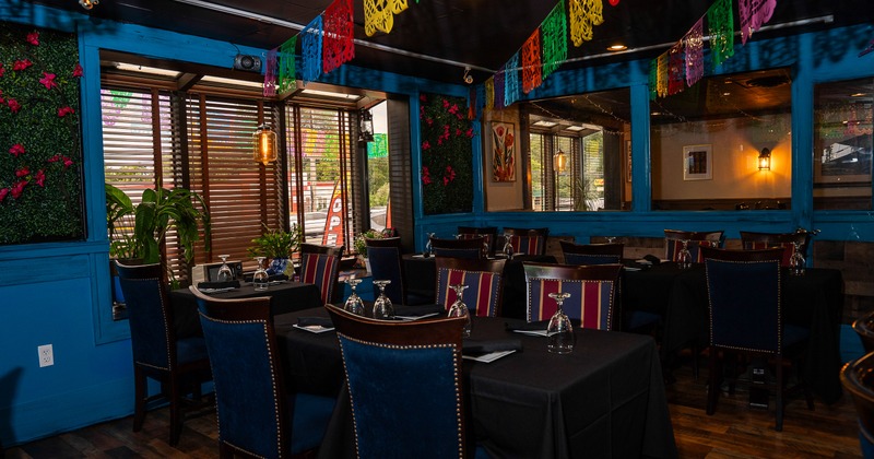 Cozy Mexican-style interior dining area decorated with hanging paper ornaments