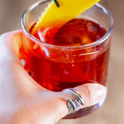 Negroni cocktail garnished with a lemon peel.