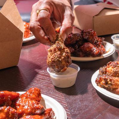 Garlic chicken wing dipped in sauce.